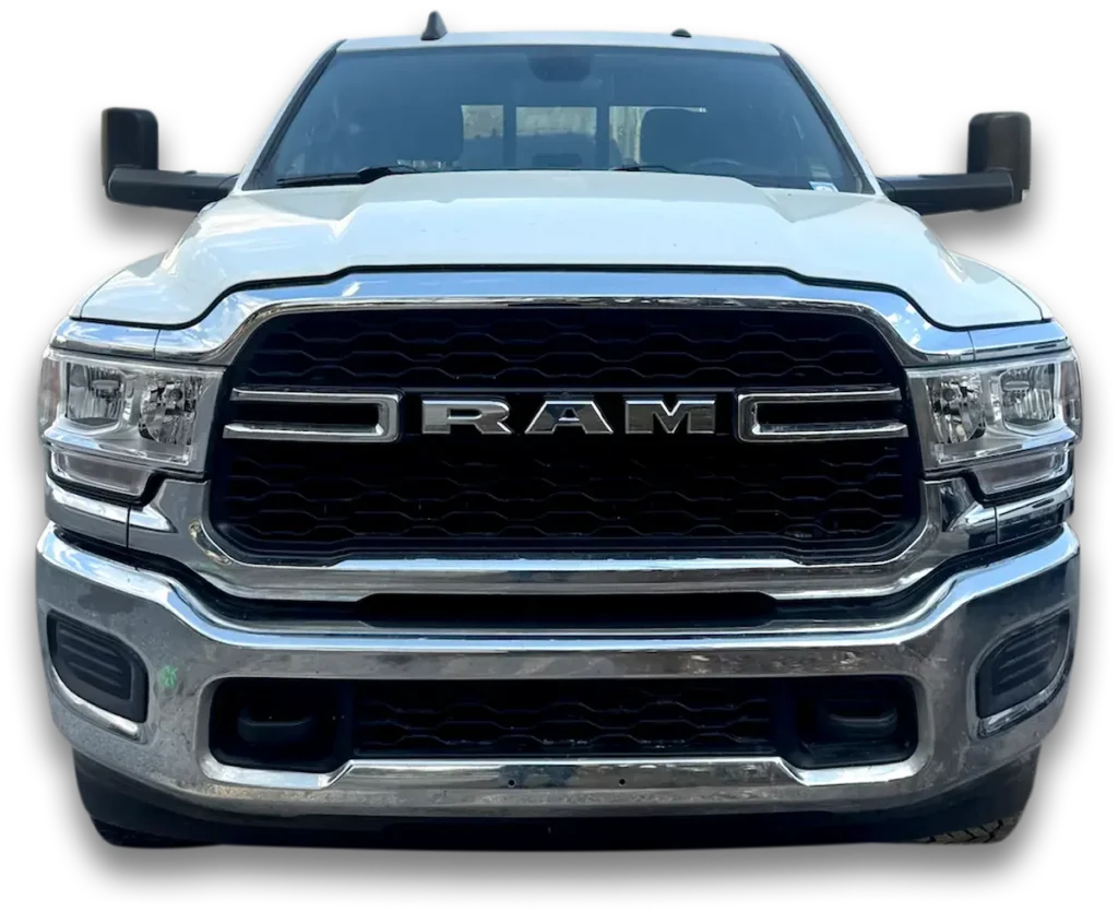 A front view of a white RAM truck, likely a 2024 RAM 2500 or 3500 Tradesman, showcasing its grille with the bold "RAM" lettering, headlights, and chrome bumper. The truck has large side mirrors, and the image is set against a transparent background.