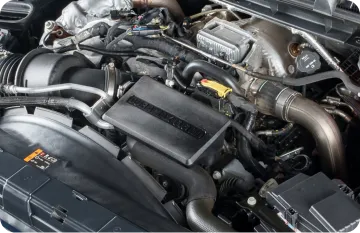 A detailed close-up shows the intricate components of a car engine.